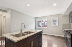 Kitchen island featuring a double basin stainless steel sink and a gooseneck faucet - 