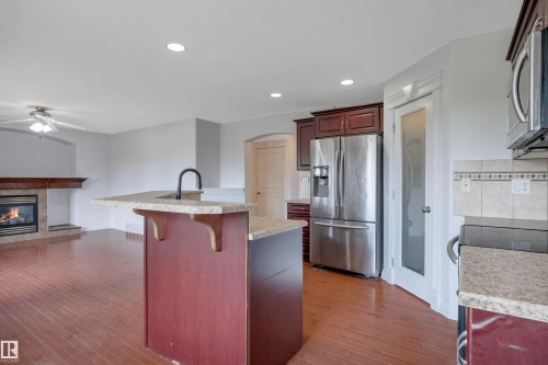 24 Birchmont Drive, Leduc, AB - Indoor Photo Showing Kitchen With Fireplace