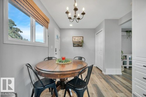 Vinyl plank flooring throughout, complemented by a decorative chandelier and recessed lighting - #138 5231 51 St, Bon Accord, AB - Indoor Photo Showing Dining Room