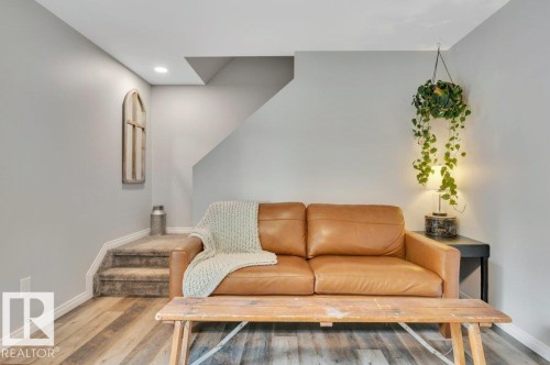 Vinyl Plank flooring, recessed lighting, and carpeted stairs - #138 5231 51 St, Bon Accord, AB - Indoor Photo Showing Living Room