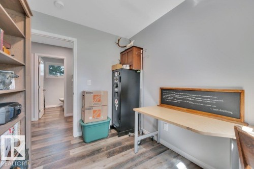 Vinyl plank flooring throughout, with light gray painted walls and white trim - #138 5231 51 St, Bon Accord, AB - Indoor Photo Showing Other Room