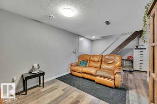 Vinyl PLank flooring with a textured ceiling, painted walls, and built-in overhead lighting - #138 5231 51 St, Bon Accord, AB - Indoor