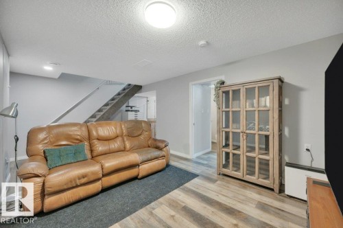 Wood-finish flooring, light gray wall paint, recessed lighting, and a visible staircase - #138 5231 51 St, Bon Accord, AB - Indoor