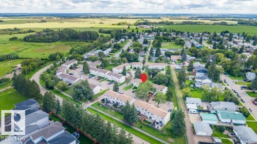 Aerial perspective showcasing a residential community with townhomes and detached properties - #138 5231 51 St, Bon Accord, AB - Outdoor With View