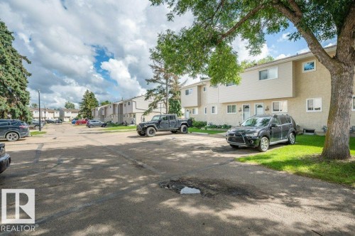 Row of attached townhomes featuring light-colored stucco and siding exteriors - #138 5231 51 St, Bon Accord, AB - Outdoor