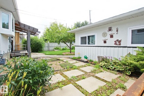 Paved stone pathway with surrounding gravel and plantings - 5712 113B Street Nw, Edmonton, AB - Outdoor