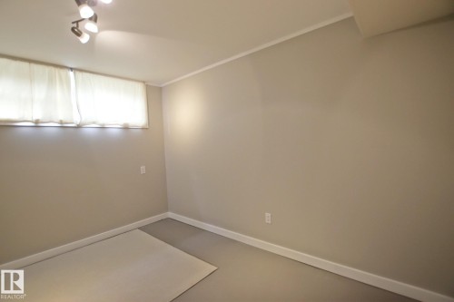 Recessed window, track lighting, painted walls, and finished flooring - 5712 113B Street Nw, Edmonton, AB - Indoor Photo Showing Other Room