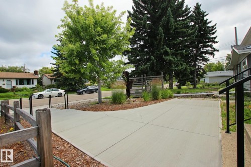 Concrete driveway with split-rail fence - 5712 113B Street Nw, Edmonton, AB - Outdoor
