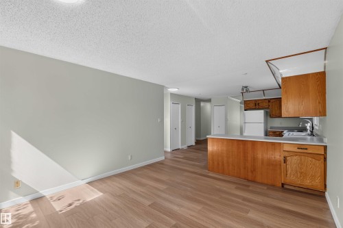 Open-concept living space featuring wood-finish flooring, light gray walls, and recessed lighting - 14725 43A Avenue Nw, Edmonton, AB - Indoor Photo Showing Kitchen