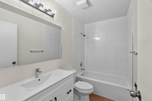 White vanity with integrated sink, chrome faucet, and black hardware - 14725 43A Avenue Nw, Edmonton, AB - Indoor Photo Showing Bathroom