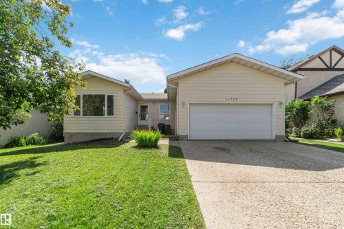 Light-colored siding exterior with an attached garage, concrete driveway, front entrance, and a bay window - 14725 43A Avenue Nw, Edmonton, AB - Outdoor