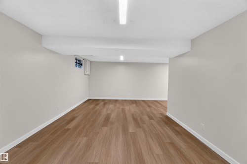 Bright interior with wood-finish flooring, light neutral wall paint, and recessed ceiling lighting - 14725 43A Avenue Nw, Edmonton, AB - Indoor Photo Showing Other Room