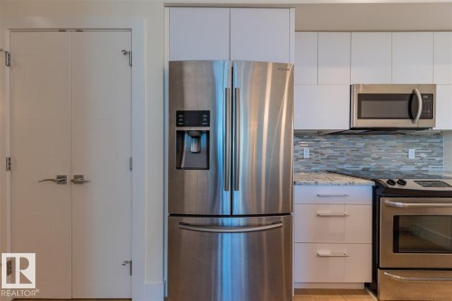#401 11969 Jasper Av Nw, Edmonton, AB - Indoor Photo Showing Kitchen With Stainless Steel Kitchen