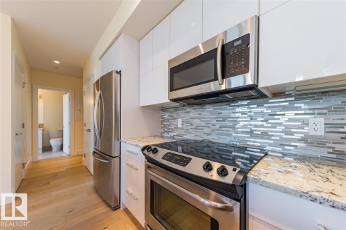 #401 11969 Jasper Av Nw, Edmonton, AB - Indoor Photo Showing Kitchen With Stainless Steel Kitchen With Upgraded Kitchen