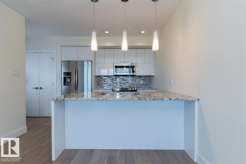 #401 11969 Jasper Av Nw, Edmonton, AB - Indoor Photo Showing Kitchen With Upgraded Kitchen