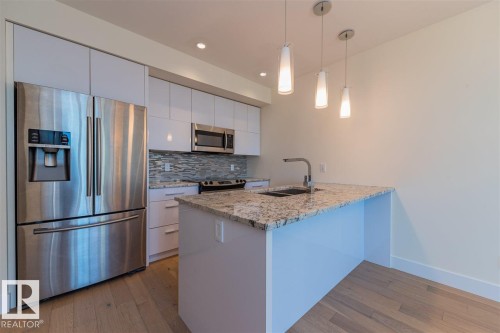 #401 11969 Jasper Av Nw, Edmonton, AB - Indoor Photo Showing Kitchen With Stainless Steel Kitchen With Double Sink With Upgraded Kitchen