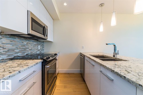#401 11969 Jasper Av Nw, Edmonton, AB - Indoor Photo Showing Kitchen With Stainless Steel Kitchen With Double Sink With Upgraded Kitchen