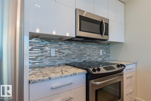 #401 11969 Jasper Av Nw, Edmonton, AB - Indoor Photo Showing Kitchen With Upgraded Kitchen