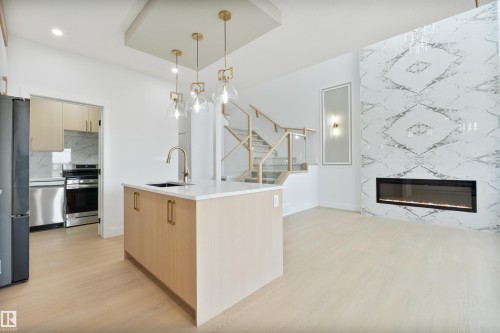 573 Ashgrove Circle, Leduc, AB - Indoor Photo Showing Kitchen With Fireplace