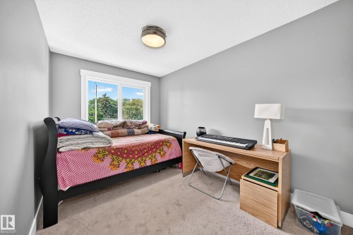 Recessed window with white trim, light gray painted walls, and ceiling-mounted light fixture - 12730 118 Street Nw, Edmonton, AB - Indoor Photo Showing Bedroom