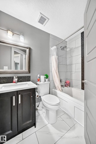White tiled flooring - 12730 118 Street Nw, Edmonton, AB - Indoor Photo Showing Bathroom