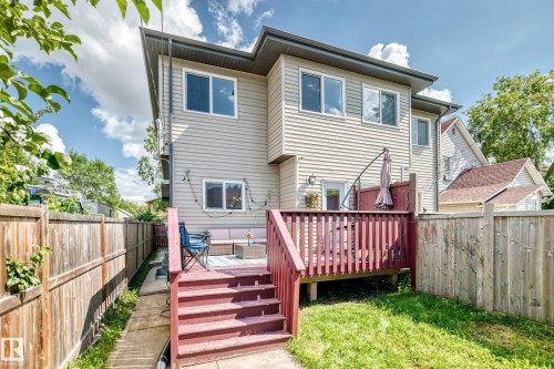 Multi-level exterior with siding, a raised wood deck, and a fenced backyard - 12730 118 Street Nw, Edmonton, AB - Outdoor With Deck Patio Veranda