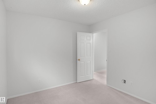 Neutral-toned wall paint with light-colored carpeting - 907 Jordan Crescent Nw, Edmonton, AB - Indoor Photo Showing Other Room
