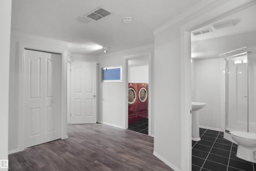 Wide plank wood-finish flooring throughout, bright white walls, and track lighting - 907 Jordan Crescent Nw, Edmonton, AB - Indoor Photo Showing Other Room