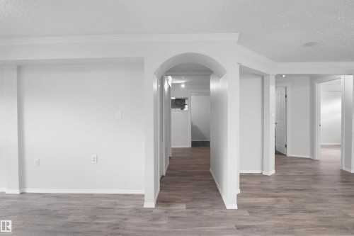 Archway entry with wood-finish flooring, white walls, and recessed lighting - 907 Jordan Crescent Nw, Edmonton, AB - Indoor Photo Showing Other Room