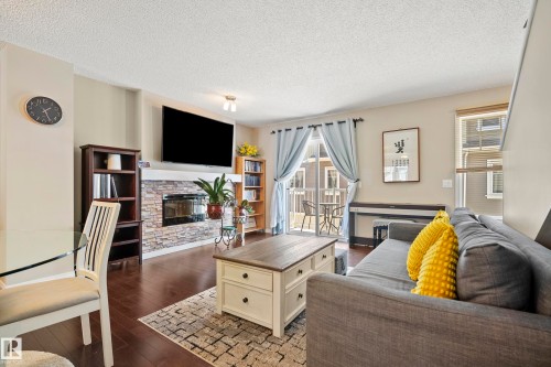 #81 4050 Savaryn Dr Sw, Edmonton, AB - Indoor Photo Showing Living Room With Fireplace