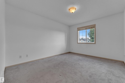 Spacious and bright primary bedroom can fit a king or queen sized bed with space! - 14031 136 Street Nw, Edmonton, AB - Indoor Photo Showing Other Room