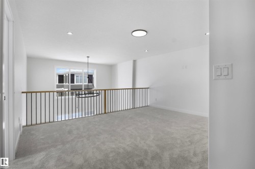 Loft area featuring grey carpeting, white walls, recessed lighting, and a modern chandelier - 3304 Chickadee Drive Nw, Edmonton, AB - Indoor Photo Showing Other Room