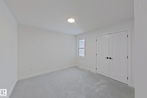 Neutral wall finishes, recessed ceiling light, white trim, light-toned carpeting, and a window with blinds - 3158 Magpie Way Nw, Edmonton, AB - Indoor Photo Showing Other Room