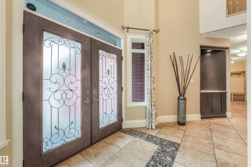 Double entry doors with decorative glass panels and transom window - 27 Kingdom Place, Leduc, AB - Indoor Photo Showing Other Room