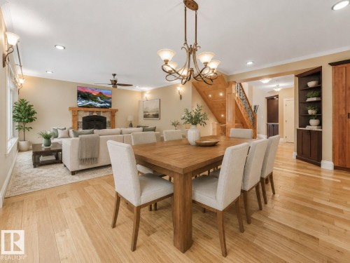 Hardwood flooring throughout, recessed lighting, and an ornate chandelier - 27 Kingdom Place, Leduc, AB - Indoor Photo Showing Dining Room