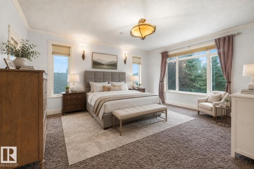 Spacious room featuring broad windows, crown molding, a central ceiling fixture, and wall-mounted sconces - 27 Kingdom Place, Leduc, AB - Indoor Photo Showing Bedroom
