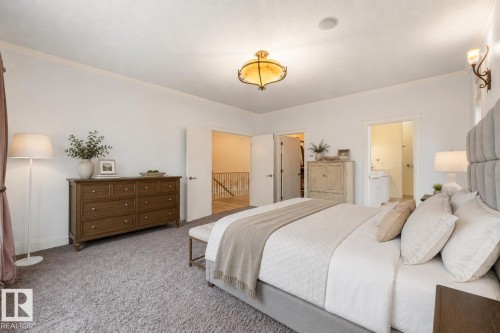 Plush carpeting, recessed lighting, and an ornate ceiling fixture - 27 Kingdom Place, Leduc, AB - Indoor Photo Showing Bedroom