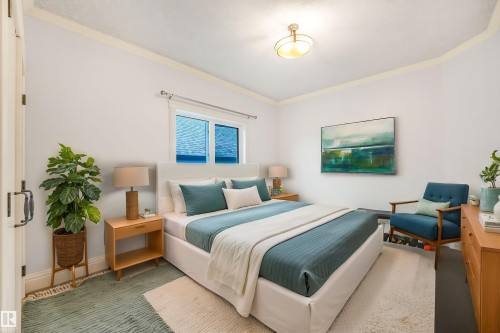 Recessed window with white trim, light-colored wall paint, crown molding, and a flush-mount ceiling light fixture - 27 Kingdom Place, Leduc, AB - Indoor Photo Showing Bedroom