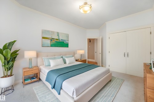 Ceiling-mounted light fixture, crown molding, and double-door closet with metal hardware - 27 Kingdom Place, Leduc, AB - Indoor Photo Showing Bedroom