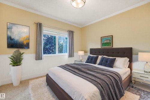 Recessed window with drapes, crown molding, chair rail molding, wall-to-wall carpeting, and a flush mount ceiling light - 27 Kingdom Place, Leduc, AB - Indoor Photo Showing Bedroom
