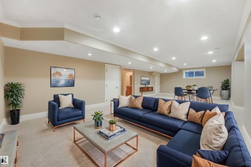 Recessed lighting illuminates the expansive open-concept living area with neutral-toned walls and light-colored carpeting - 27 Kingdom Place, Leduc, AB - Indoor Photo Showing Living Room