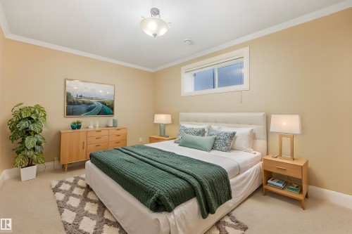 Recessed window with privacy screening, crown molding, and ceiling-mounted light fixture - 27 Kingdom Place, Leduc, AB - Indoor Photo Showing Bedroom