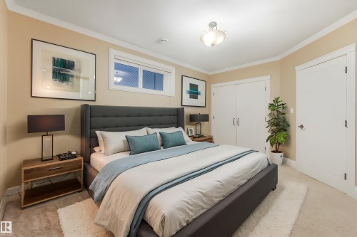 Crown molding details, recessed window, light-colored walls, ceiling-mounted light fixture, and white interior doors - 27 Kingdom Place, Leduc, AB - Indoor Photo Showing Bedroom
