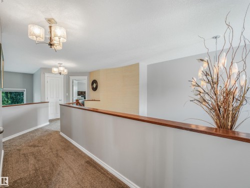 Carpeted hallway with wood-capped half-walls - 967 Lamb Crescent Nw, Edmonton, AB - Indoor Photo Showing Other Room