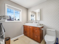 Wood-finish double vanity with a white countertop and dual vessel sinks - 