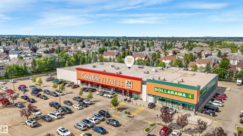 Retail property with extensive surface parking, prominent tenant signage, and surrounding residential area - 967 Lamb Crescent Nw, Edmonton, AB - Outdoor With View