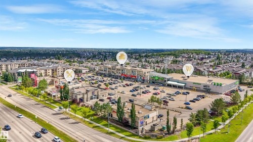 Comprehensive commercial center with ample surface parking, surrounded by residential properties and accessible via a multi-lane roadway - 967 Lamb Crescent Nw, Edmonton, AB - Outdoor With View