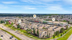 Comprehensive commercial center with ample surface parking, surrounded by residential properties and accessible via a multi-lane roadway - 