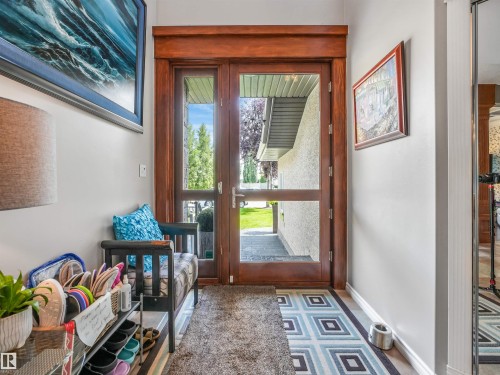Wood-finish double entry doors with transom window - 967 Lamb Crescent Nw, Edmonton, AB - Indoor Photo Showing Other Room
