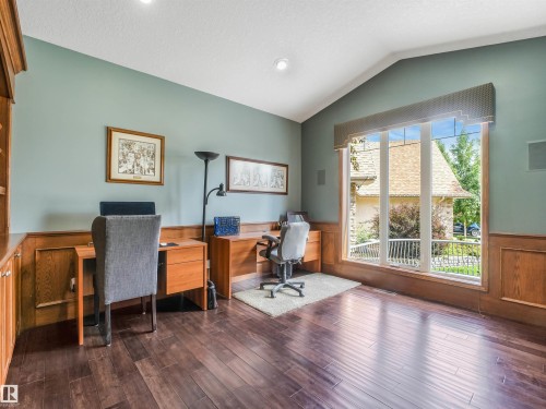 Vaulted ceiling with recessed lighting, wood-finish flooring, wood paneling, and a large bay window - 967 Lamb Crescent Nw, Edmonton, AB - Indoor Photo Showing Office
